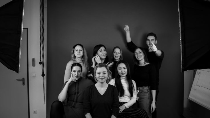 A group of people against a dark background