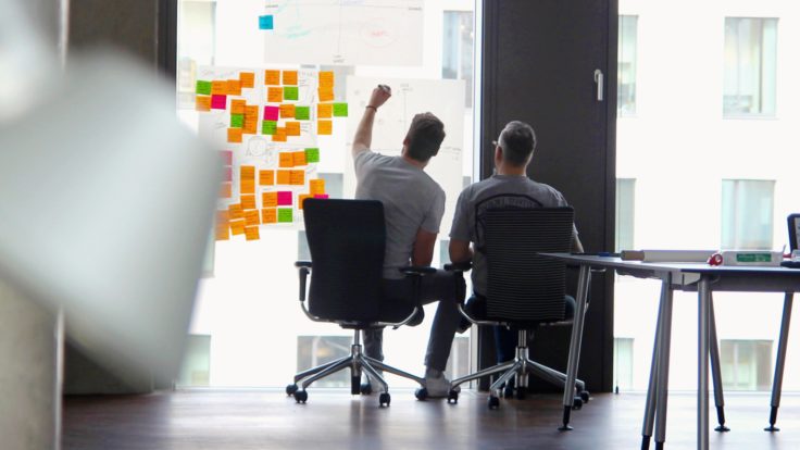Two employees brainstorming during a workshop
