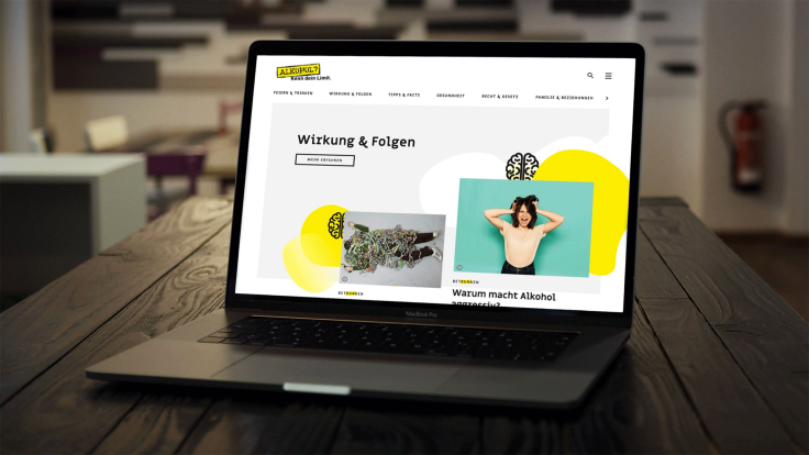 Laptop sitting on a table shows the website of the campaign