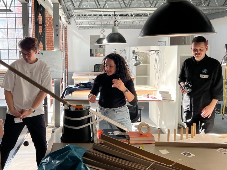 Three people work on one project in the office