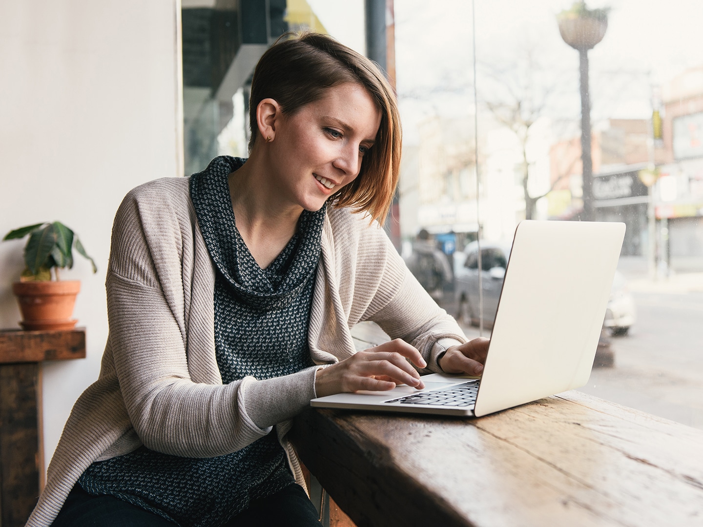 Frau arbeitet an ihrem Laptop in einem Café