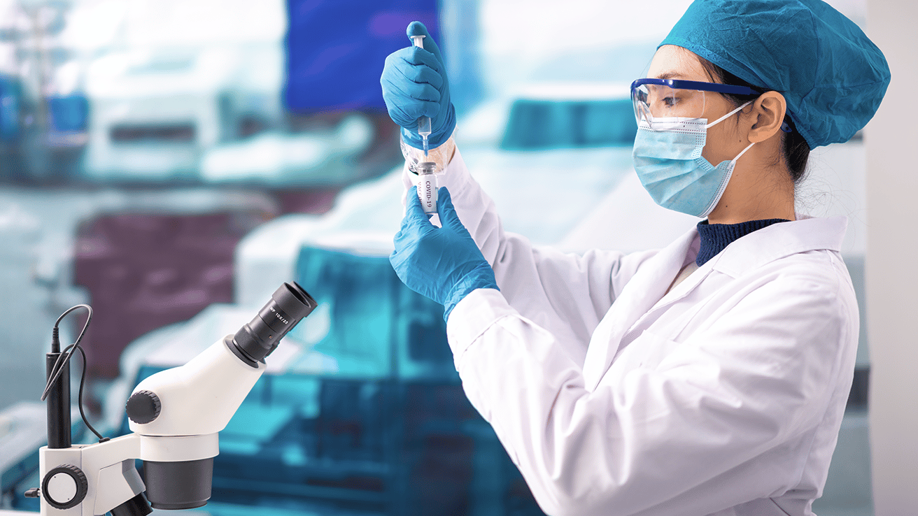 Woman in white lab coat with a syringe. 