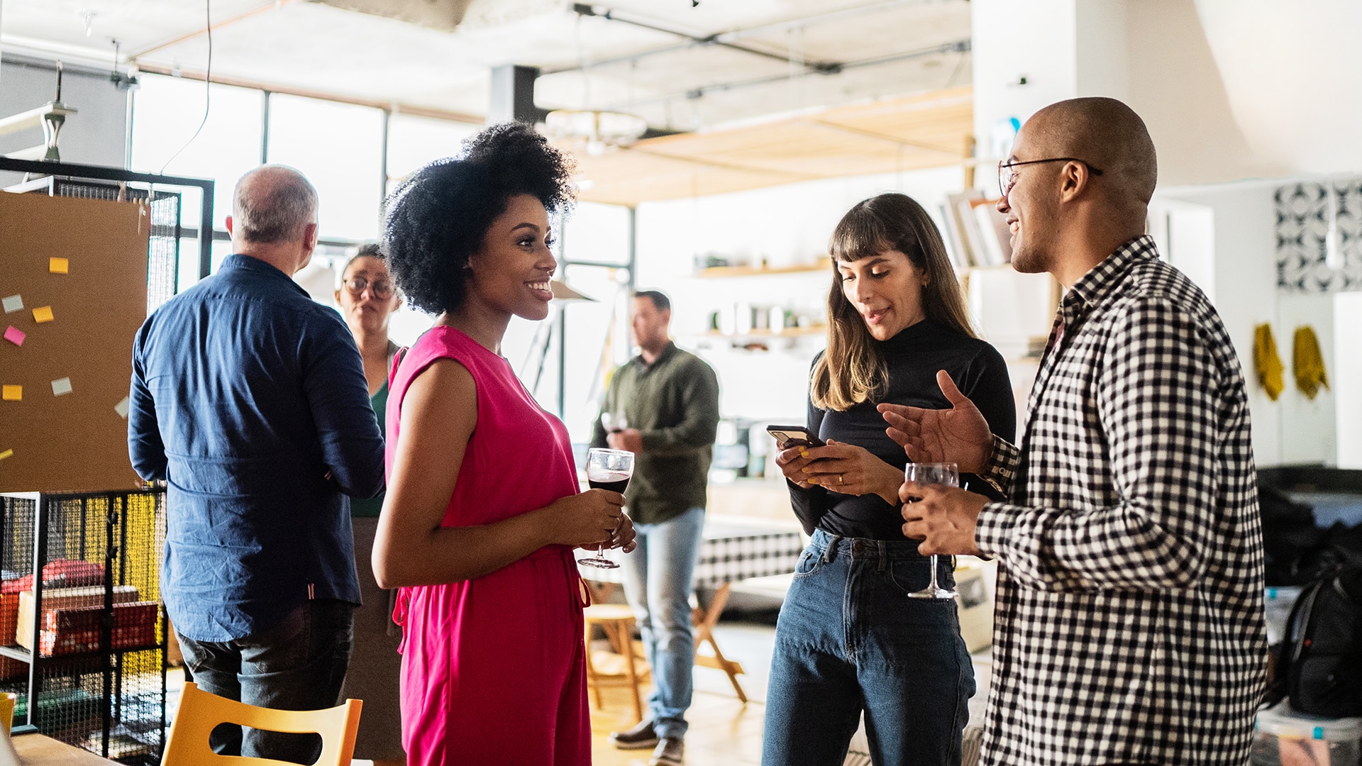 professional exchange in a social setting. 6 people talking to each other