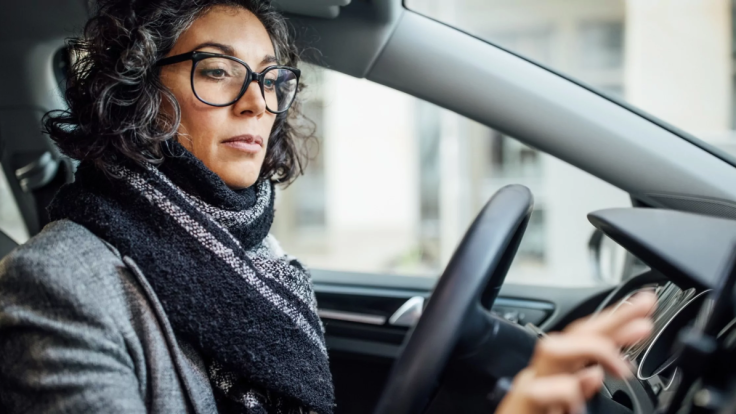 An illustration showing a woman in a car.